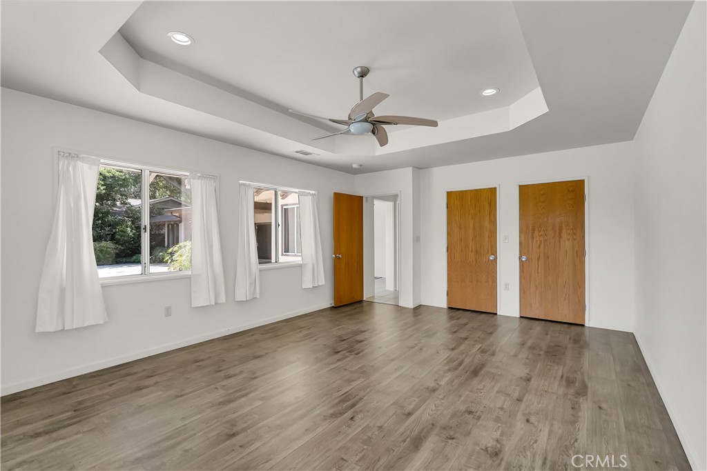 4907 Cliffside Drive Riverside, CA 92506 - Photo 23 of 29 a view of an empty room with a window and wooden floor