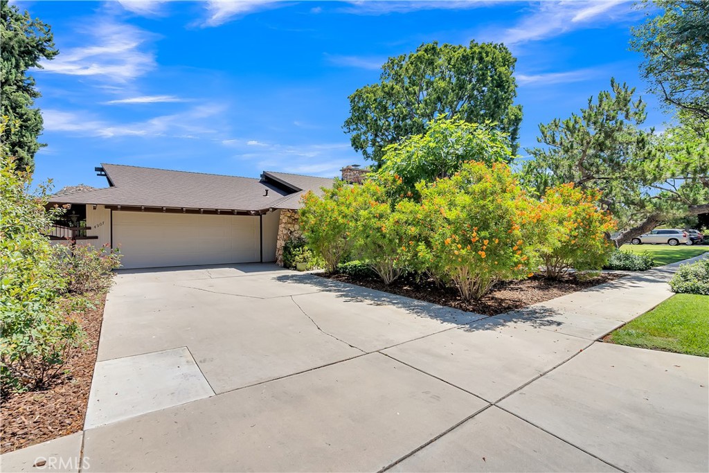4907 Cliffside Drive Riverside, CA 92506 - Photo 3 of 29 a front view of a house with a yard and garage