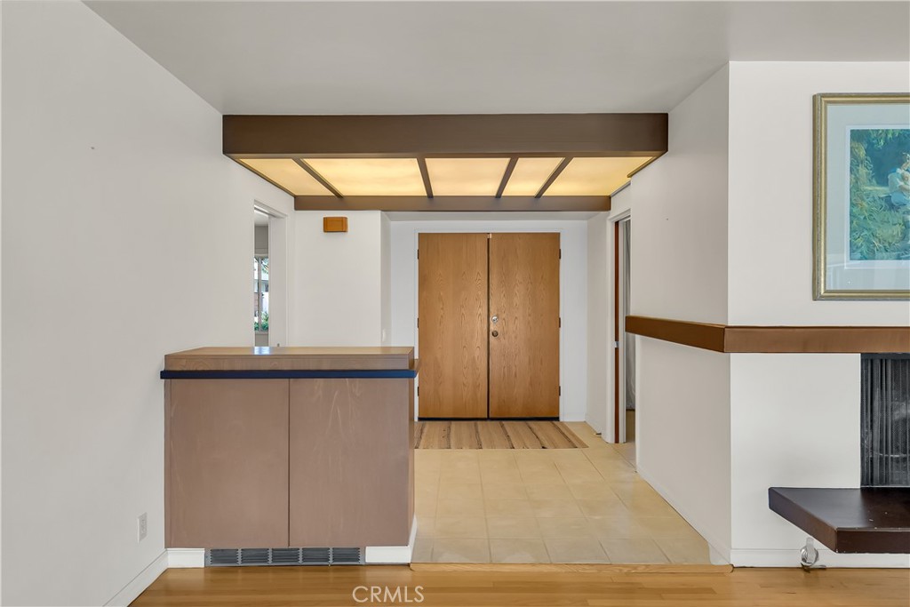 4907 Cliffside Drive Riverside, CA 92506 - Photo 5 of 29 a view of a hallway with wooden floor and a potted plant