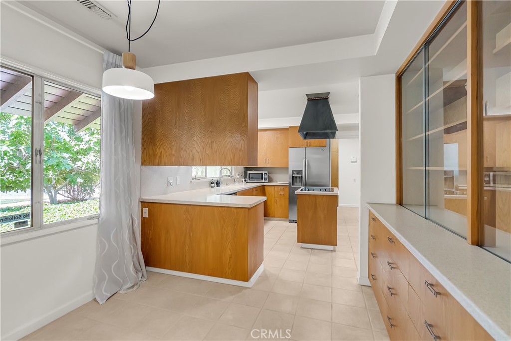 4907 Cliffside Drive Riverside, CA 92506 - Photo 6 of 29 a kitchen with stainless steel appliances granite countertop a stove a sink and a refrigerator