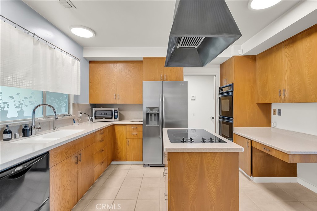 4907 Cliffside Drive Riverside, CA 92506 - Photo 8 of 29 a large kitchen with stainless steel appliances a sink dishwasher a refrigerator and a stove