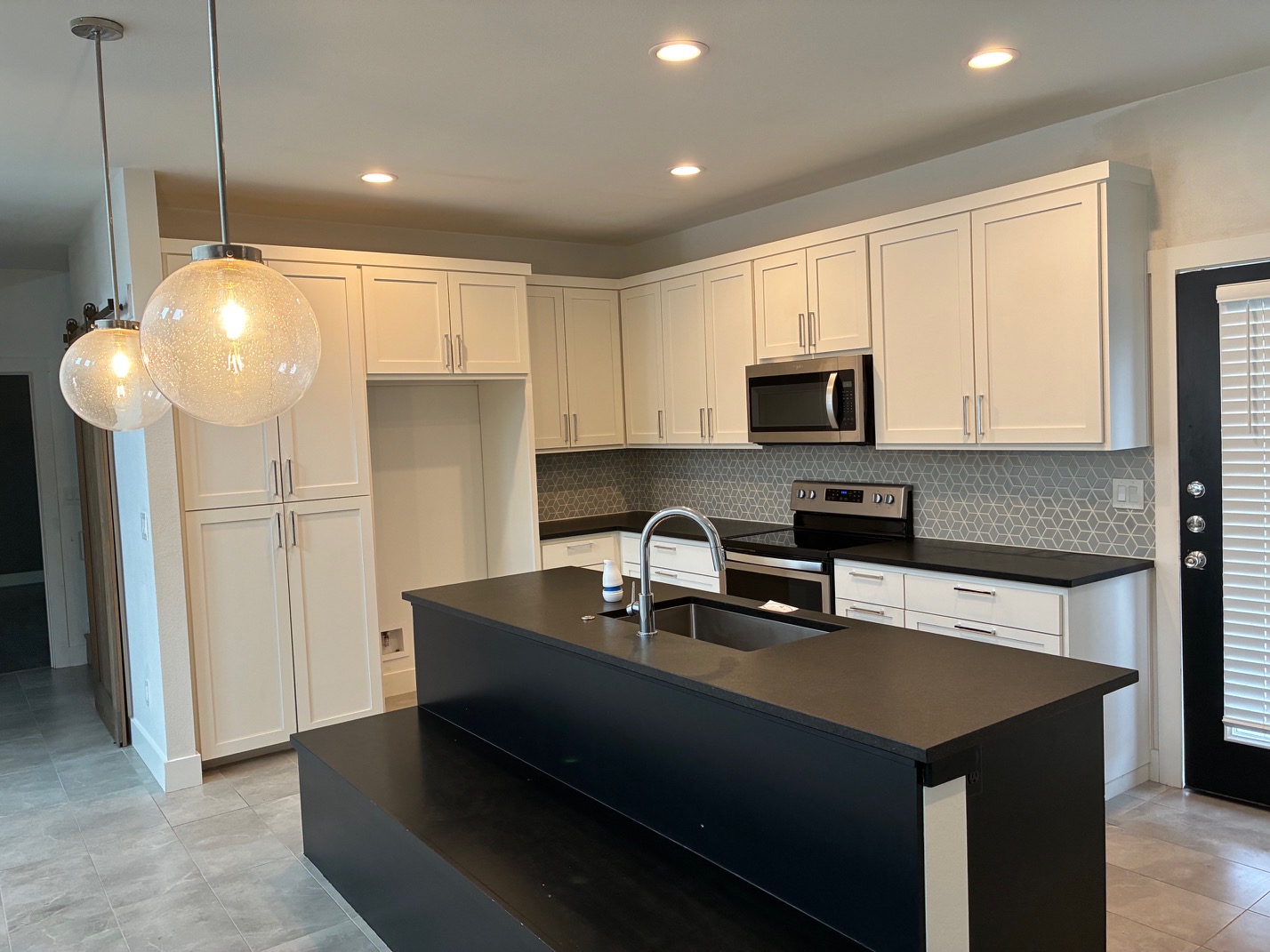 403 Summit Ridge Drive North Jonestown, TX 78645 - Photo 4 of 15 a kitchen with stainless steel appliances a refrigerator a sink a stove a microwave and island