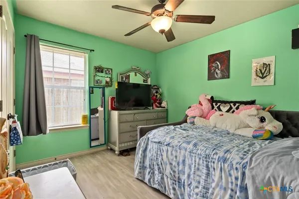 a bedroom with a bed and a flat screen tv