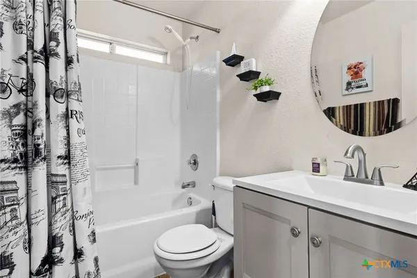 a bathroom with a toilet sink and shower