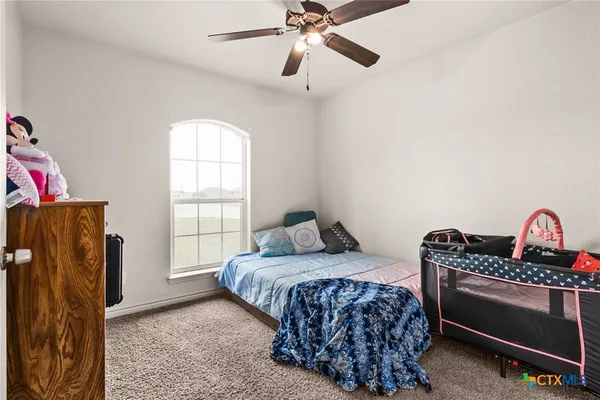 a bedroom with bed and window