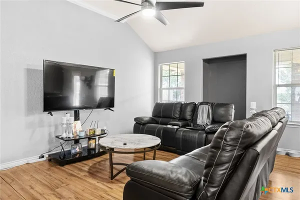 a living room with furniture and a flat screen tv