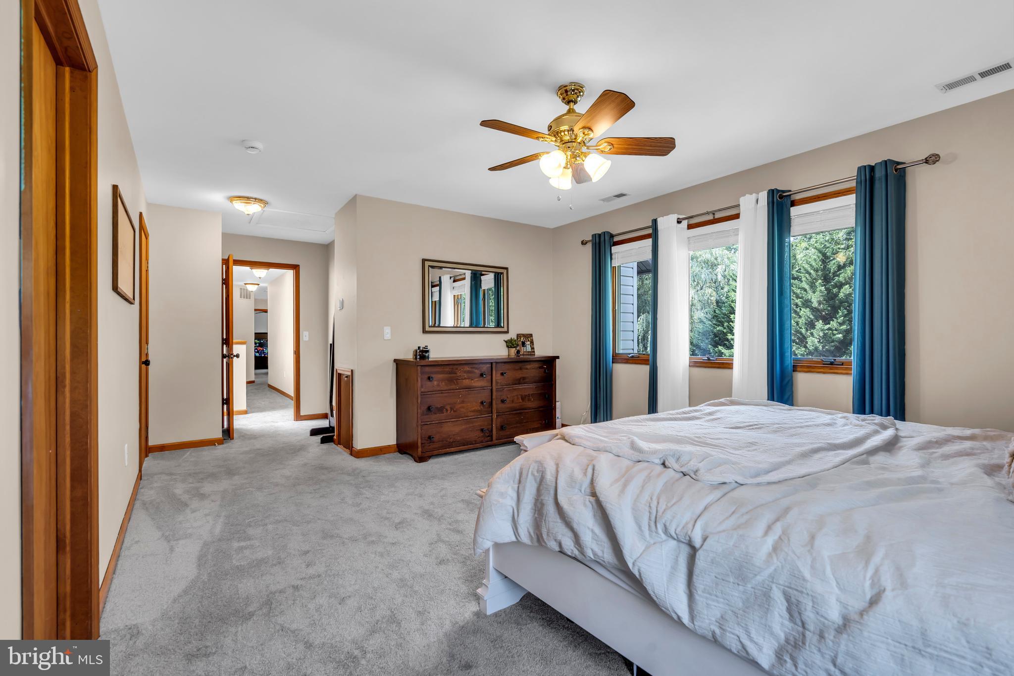 311 County House Road Sewell, NJ 08080 - Photo 32 of 52 a spacious bedroom with a balcony a bed and a chandelier