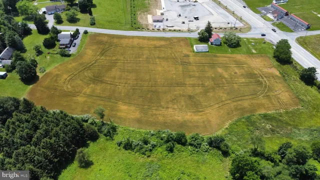 an aerial view of a house with a yard and lake view