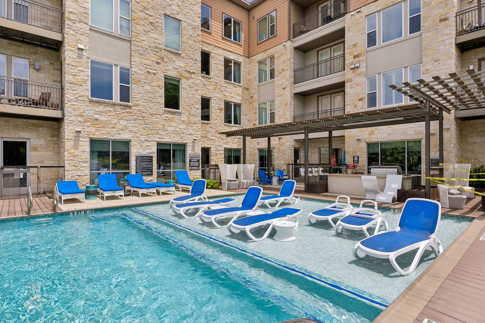 1900 Barton Springs Road, Unit 5032 Austin, TX 78704 - Photo 36 of 40 Resort-style pool with integrated tanning ledge and in-water lounge seating