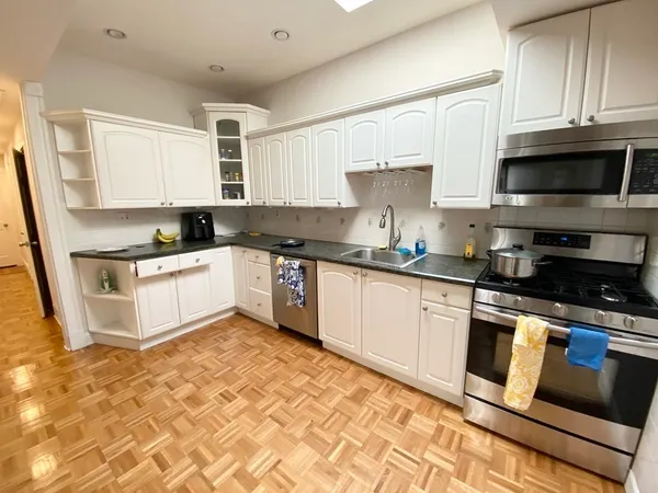 a kitchen with granite countertop a sink and cabinets
