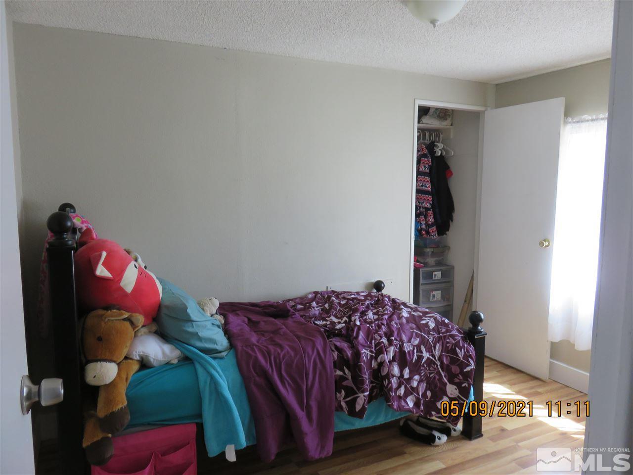 17525 Fantail Street Reno, NV 89508 - Photo 6 of 13 a bedroom with a bed and a closet