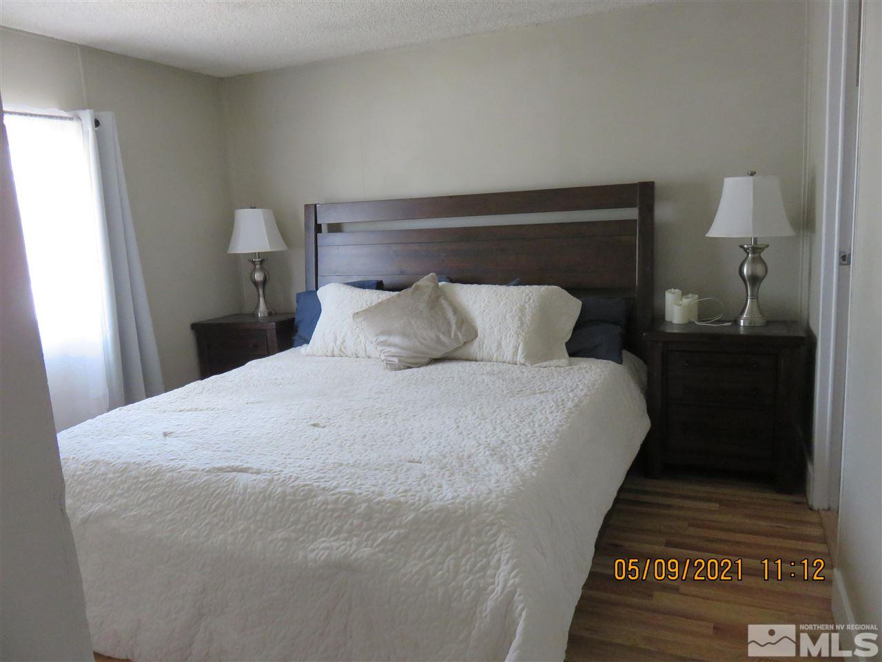 17525 Fantail Street Reno, NV 89508 - Photo 7 of 13 a large bed sitting in a bedroom next to a lamp