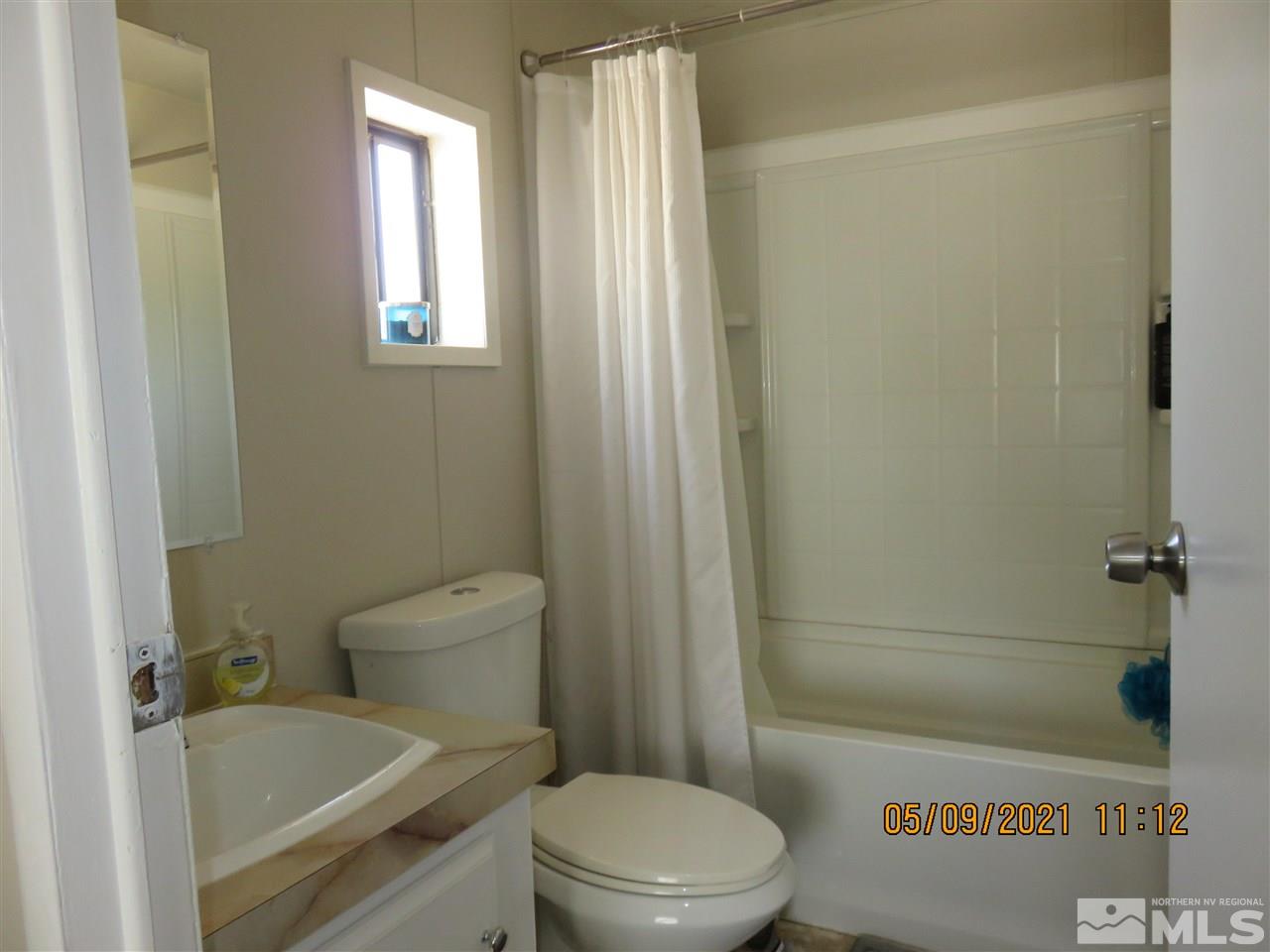 17525 Fantail Street Reno, NV 89508 - Photo 8 of 13 a white toilet sitting next to a bath tub