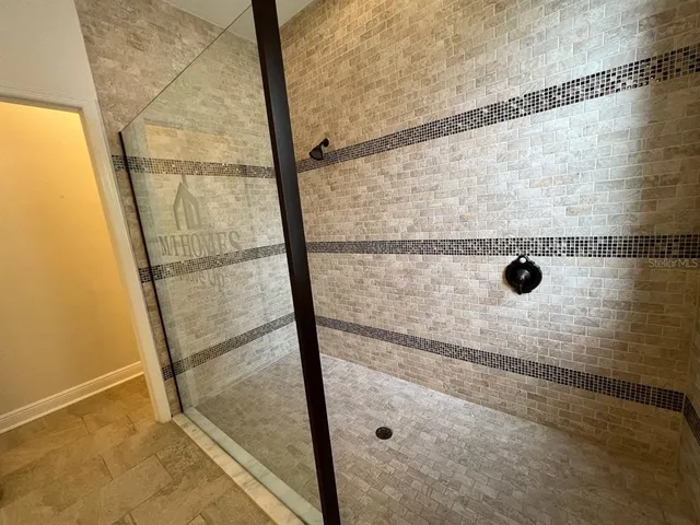 a bathroom with a glass shower door