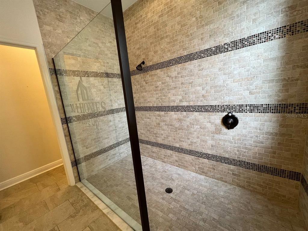 1692 Nature View Drive Lutz, FL 33558 - Photo 20 of 53 a bathroom with a glass shower door