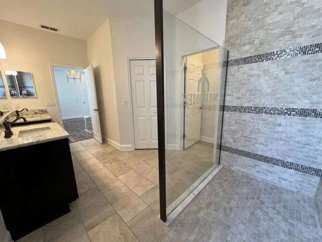 a view of a bathroom with a glass shower door