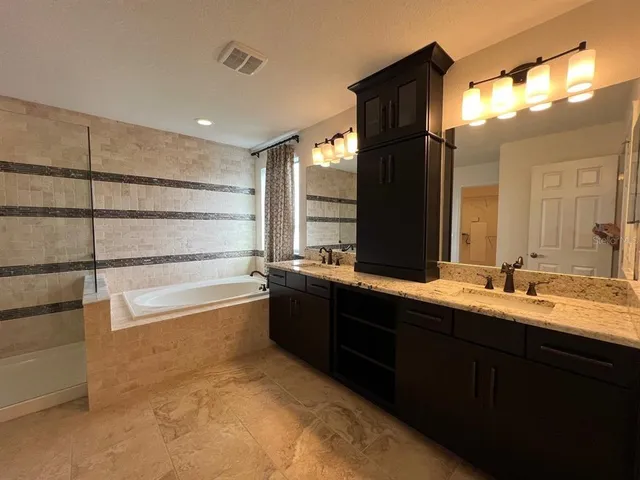 a bathroom with a double vanity sink and mirror