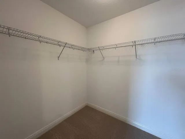 a bathroom with a sink a toilet a mirror and shower