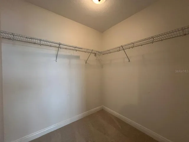 an empty room with closet and a bathroom
