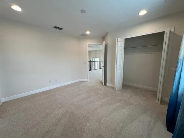 an empty room with closet and bathroom