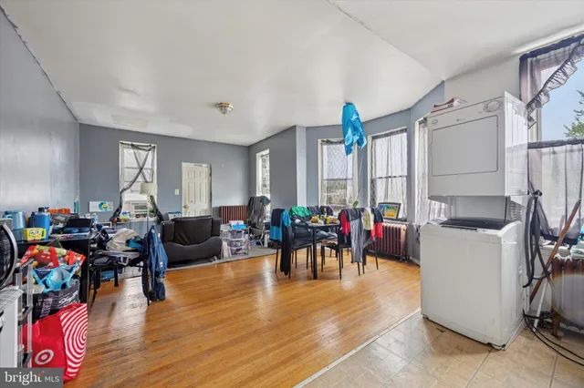 a living room filled with furniture a rug and a window