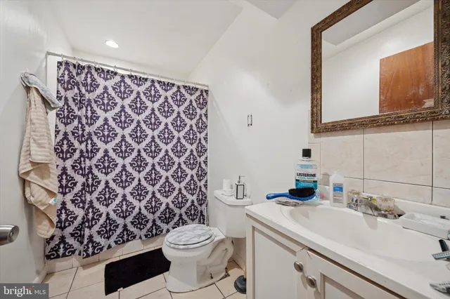 a bathroom with a sink toilet and mirror