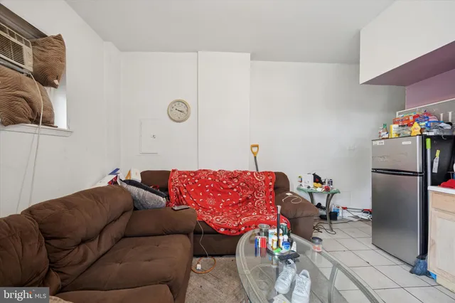 a living room with a couch and a dining table