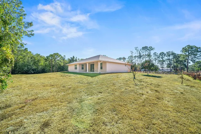 a blue swimming pool is in the middle of a field