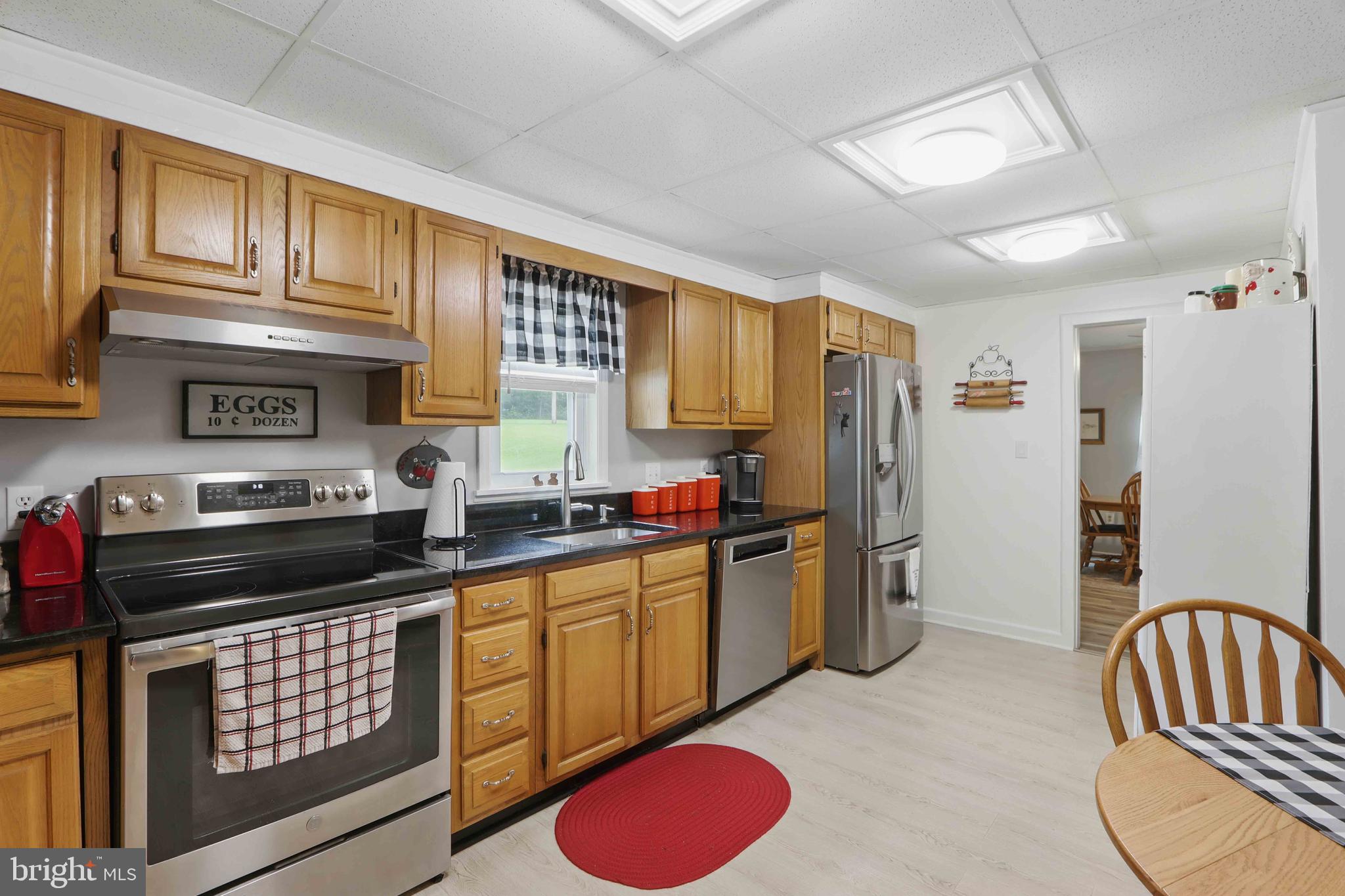 147 Darlington Road Havre de Grace, MD 21078 - Photo 27 of 52 a kitchen with stainless steel appliances granite countertop a stove a sink dishwasher and cabinets with wooden floor