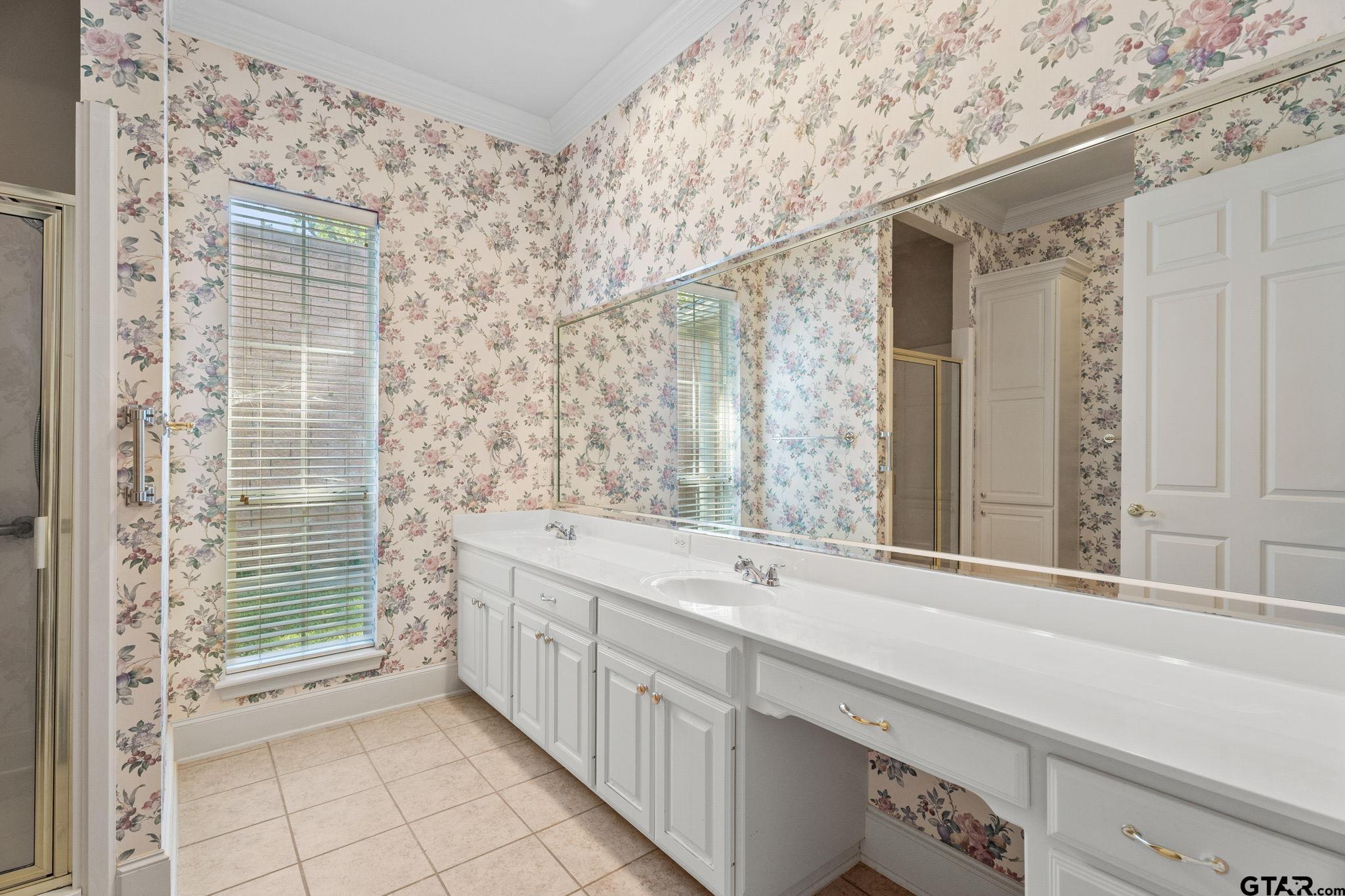 2438 Dietz Lane Tyler, TX 75701 - Photo 11 of 26 a bathroom with a double vanity sink window and a bathtub
