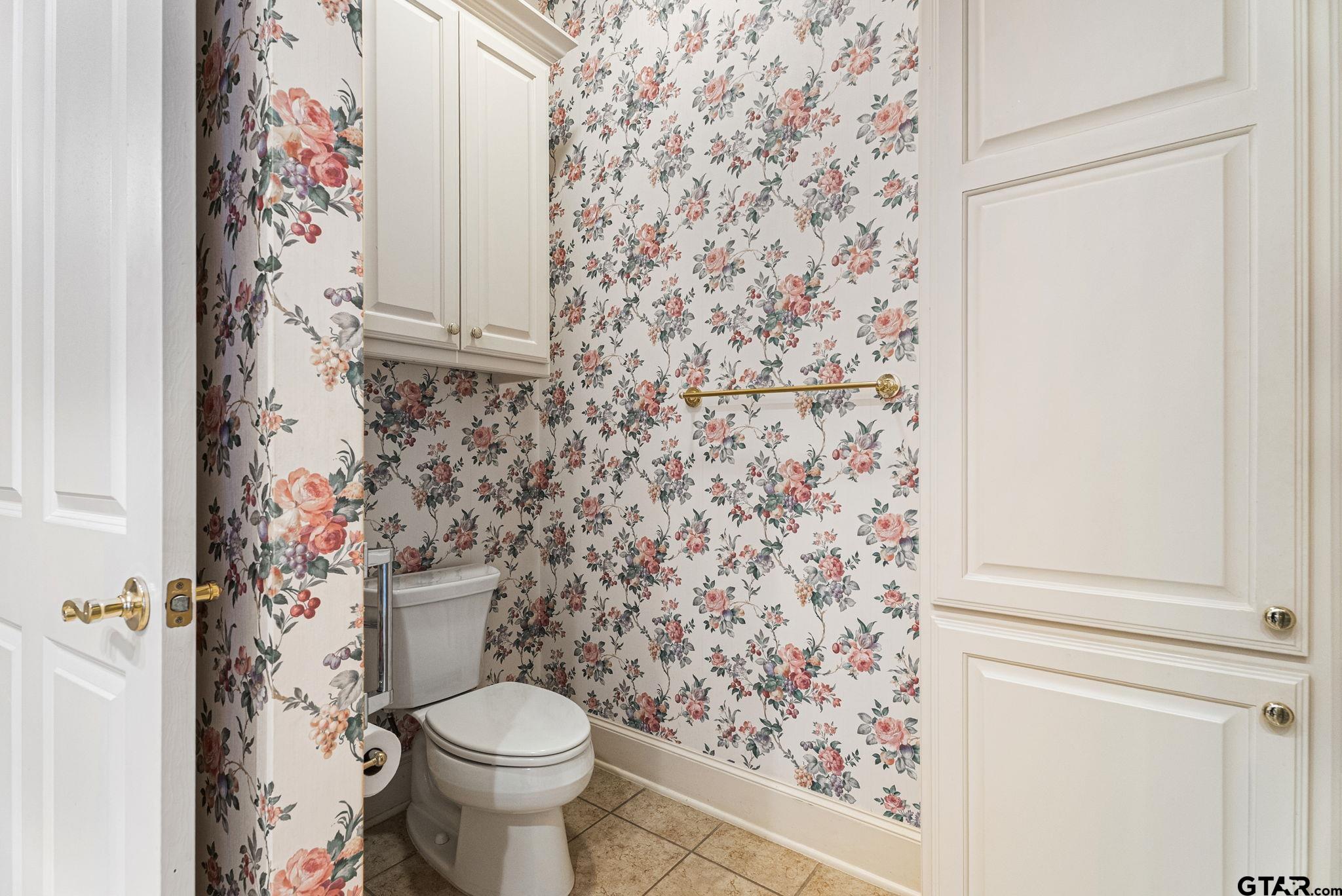 2438 Dietz Lane Tyler, TX 75701 - Photo 12 of 26 a bathroom with a toilet and a shower curtain