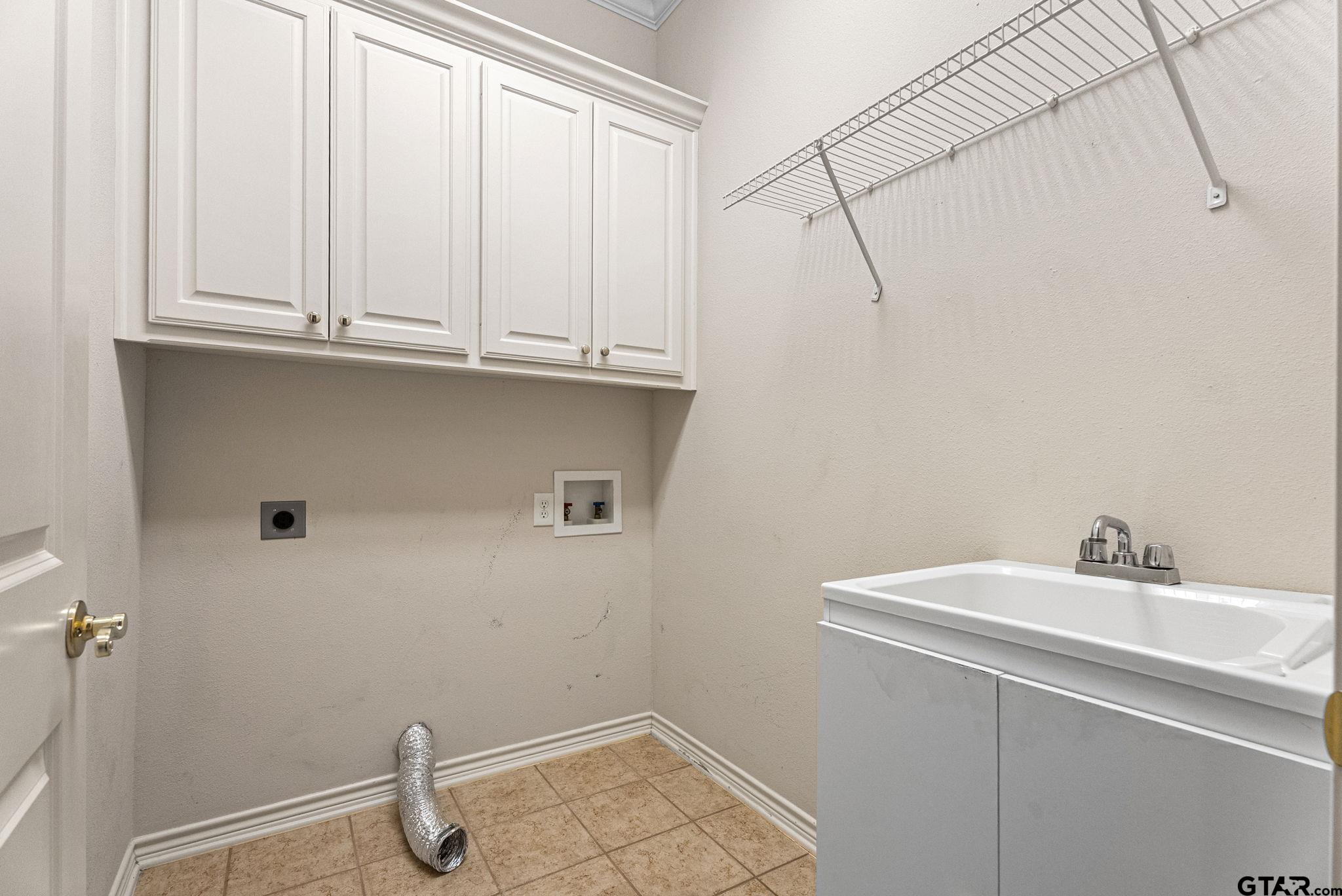 2438 Dietz Lane Tyler, TX 75701 - Photo 21 of 26 a bathroom with a sink and cabinets