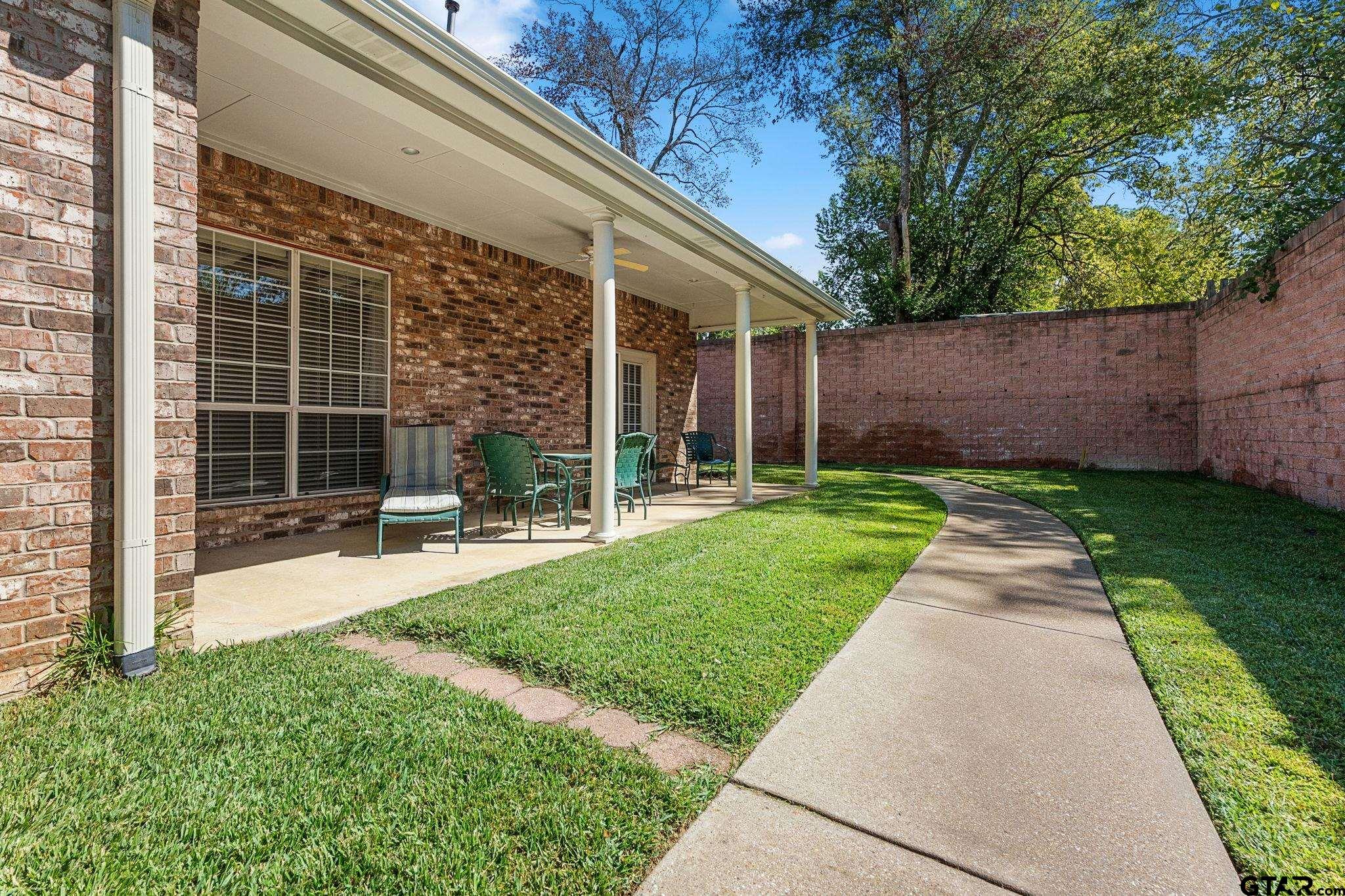 2438 Dietz Lane Tyler, TX 75701 - Photo 22 of 26 a view of a house with backyard and a garden