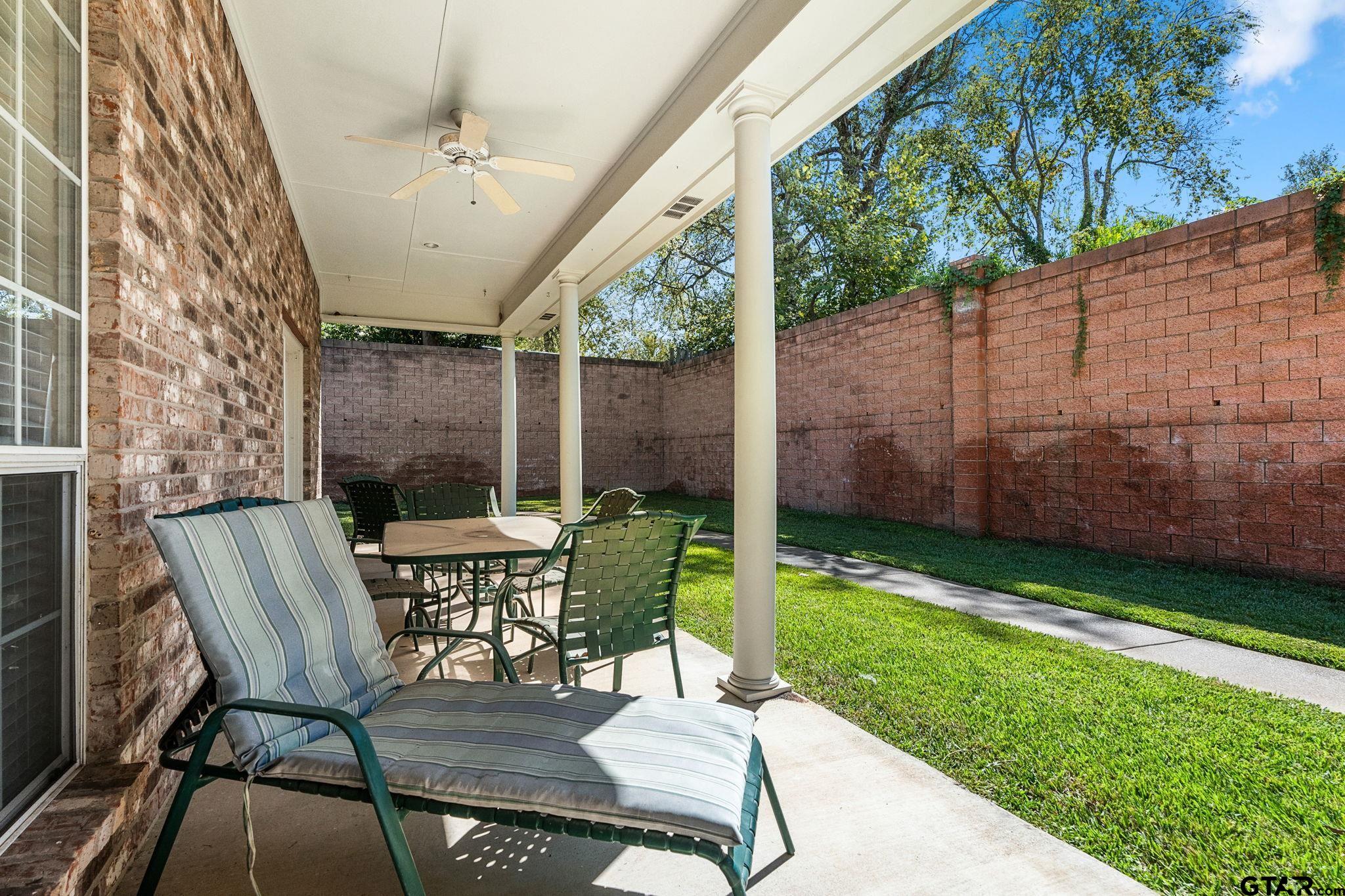 2438 Dietz Lane Tyler, TX 75701 - Photo 23 of 26 a view of a patio with a table chairs and a backyard