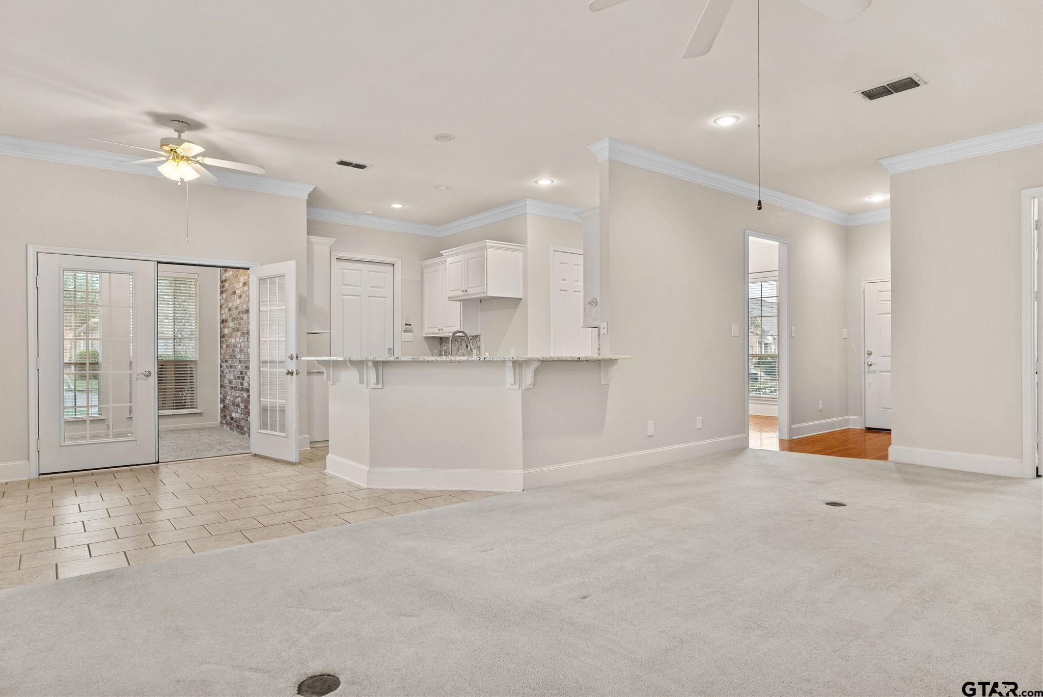 2438 Dietz Lane Tyler, TX 75701 - Photo 5 of 26 a view of an empty room with kitchen and window