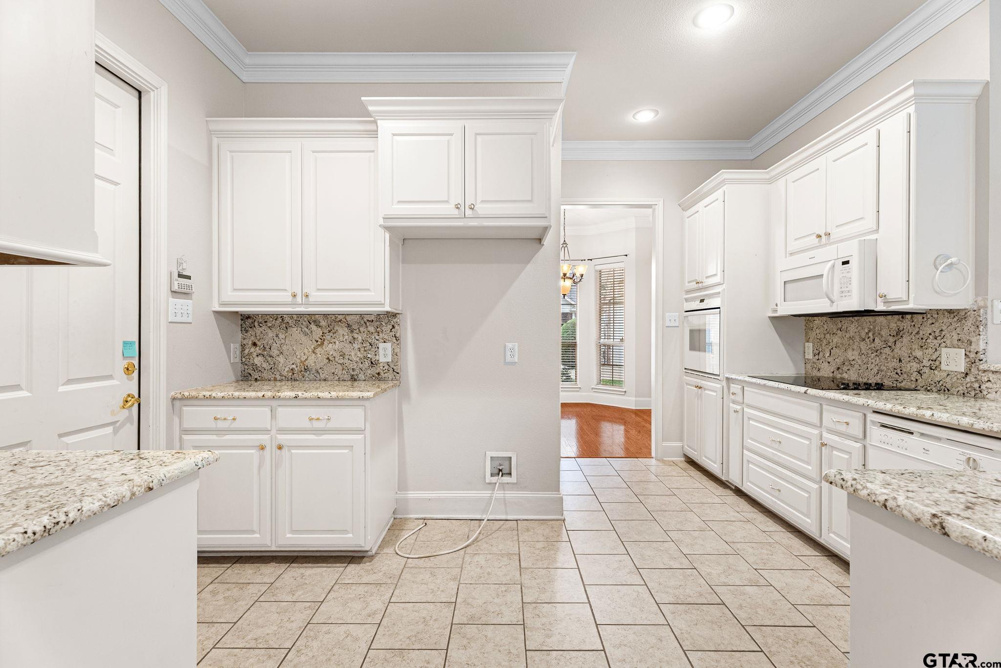2438 Dietz Lane Tyler, TX 75701 - Photo 6 of 26 a kitchen with a stove a sink and a refrigerator