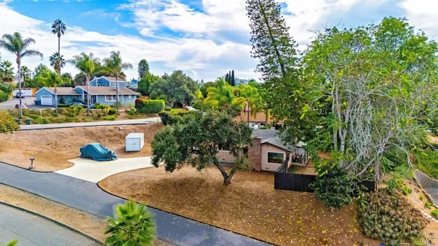 a view of a house with a yard and sitting area