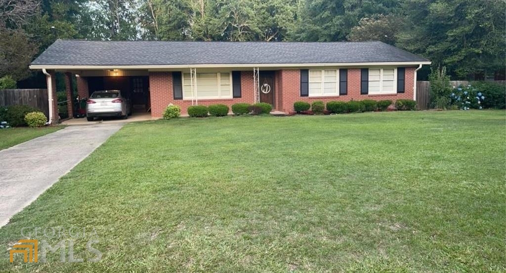 103 Maple Street Dublin, GA 31021 - Photo 1 of 1 a front view of a house with garden