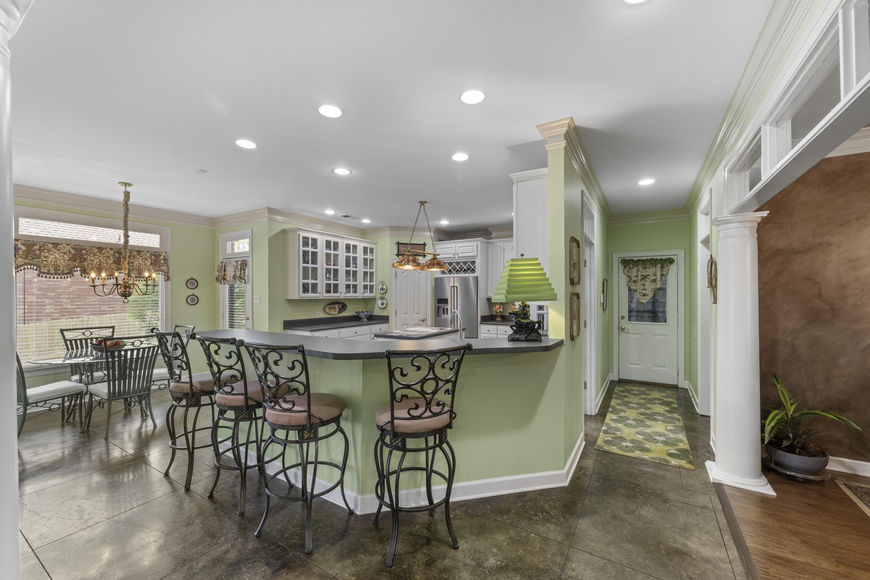 4132 Blackheath Drive Bartlett, TN 38135 - Photo 12 of 40 a kitchen with stainless steel appliances kitchen island granite countertop a table and chairs in it