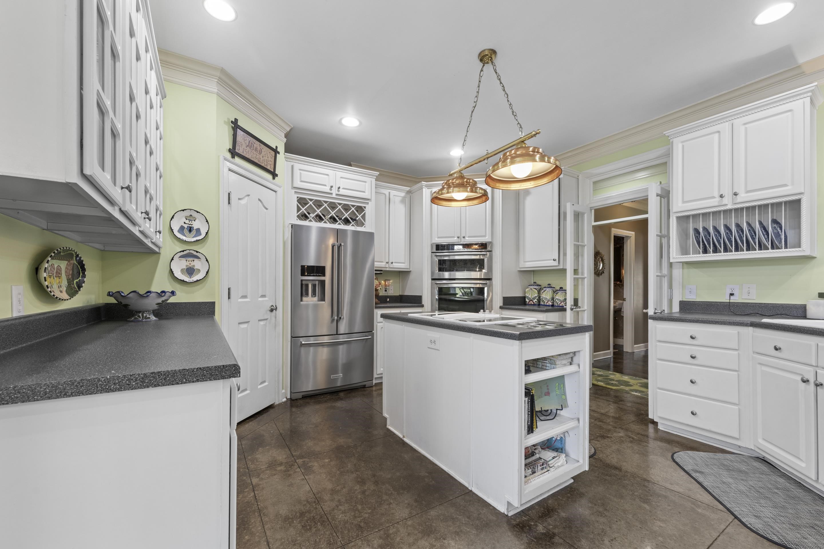 4132 Blackheath Drive Bartlett, TN 38135 - Photo 9 of 40 a kitchen with refrigerator cabinets and window