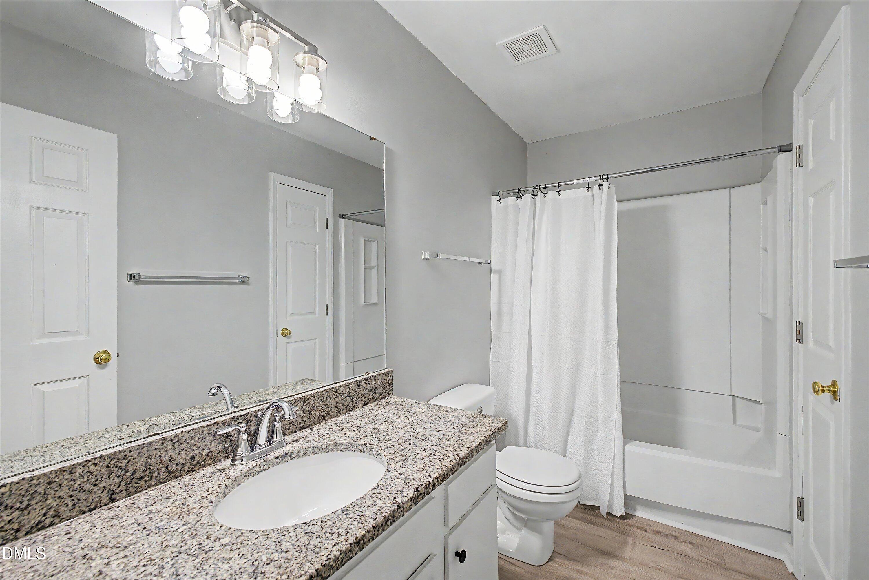 5519 Hamstead Crossing Raleigh, NC 27612 - Photo 23 of 33 a bathroom with a granite countertop sink toilet and shower