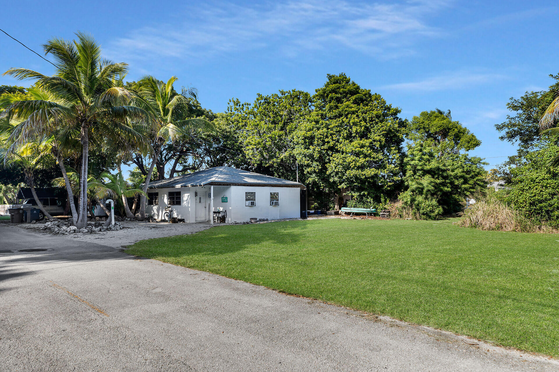 14 Miami Drive Key Largo, FL 33037 - Photo 2 of 16 a front view of a house with a yard and garage
