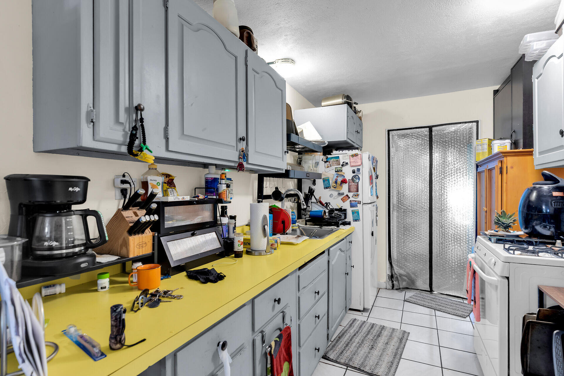 14 Miami Drive Key Largo, FL 33037 - Photo 7 of 16 a kitchen with stainless steel appliances granite countertop a sink refrigerator and cabinets