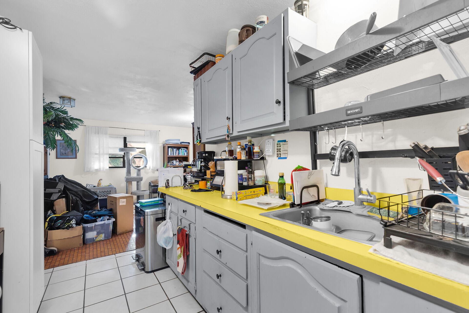14 Miami Drive Key Largo, FL 33037 - Photo 8 of 16 a kitchen with sink refrigerator and cabinets