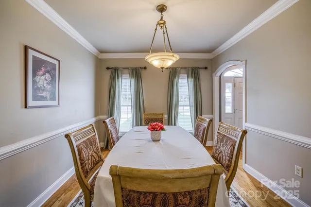 a view of a dining room with furniture and chandelier