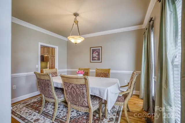 a view of a hallway with a livingroom and front door
