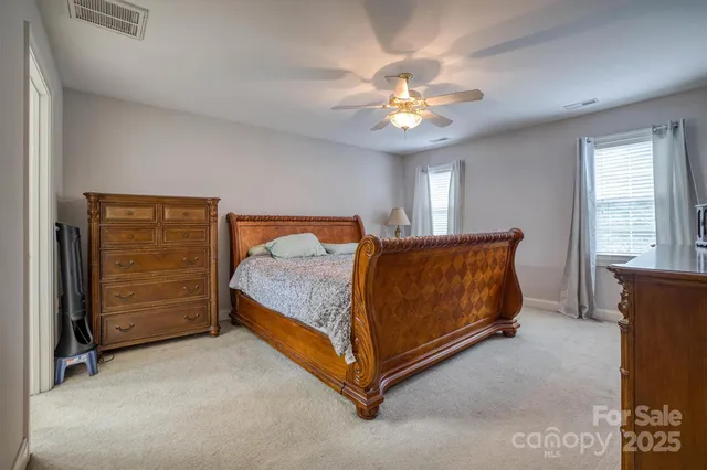 a spacious bathroom with a double vanity sink a mirror and a bathtub
