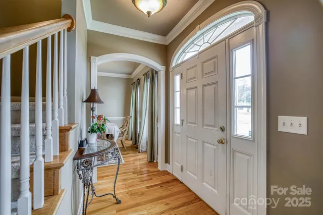 a view of an entryway with wooden floor