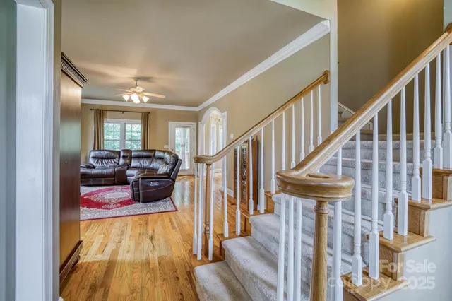 a view of entryway livingroom and hall with wooden floor