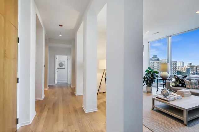 a large bedroom with a bed and large windows